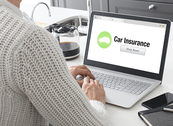 Woman on a laptop looking up car insurance