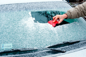 scrapping off ice from windshield