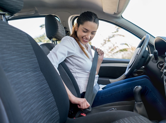 Woman Buckling Seat Belt