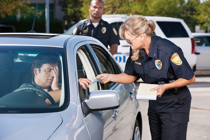 Driver Talking With Officer At Traffic Stop