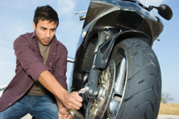 person working on motorcycle
